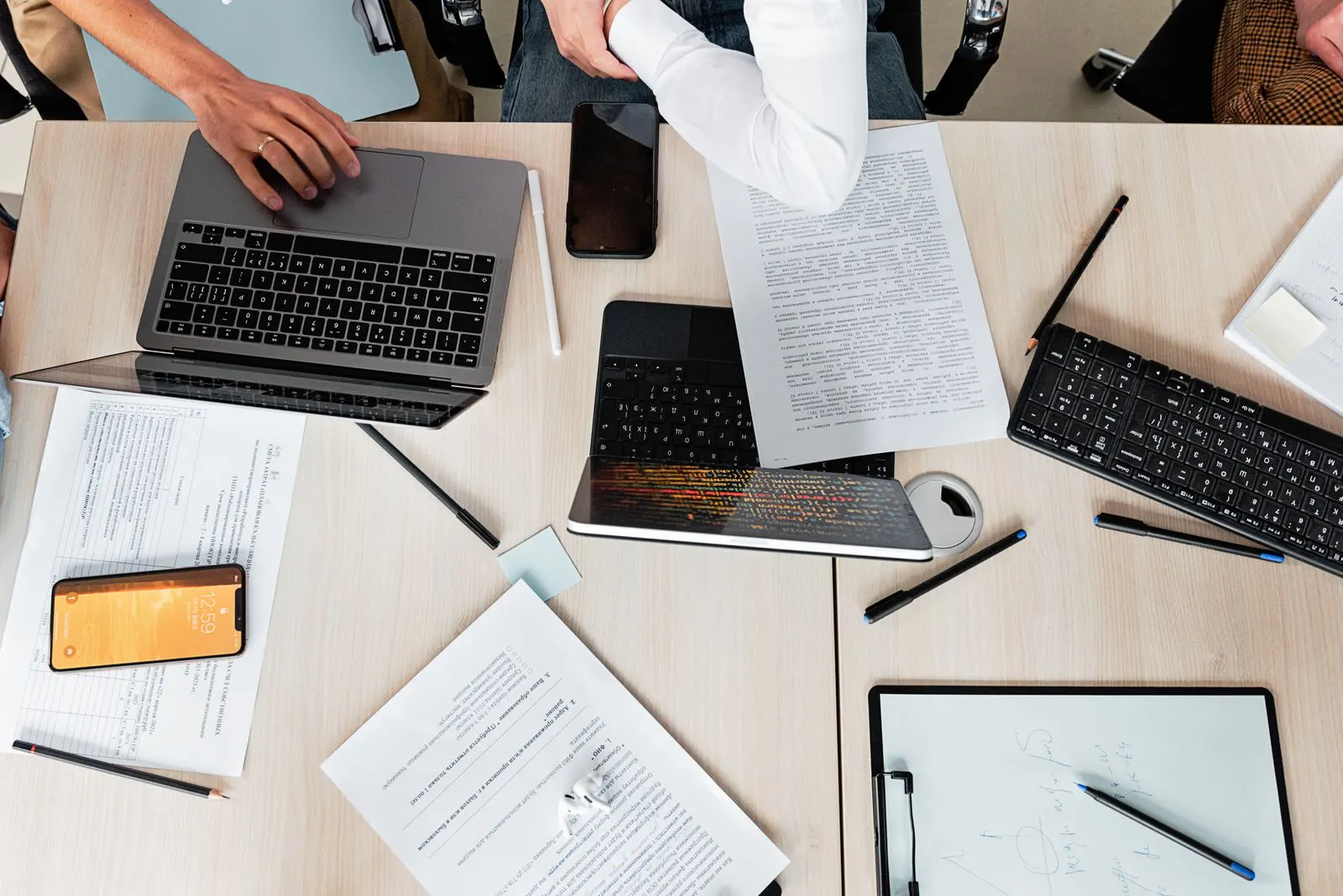 Overhead view of laptops and documents in a business workspace